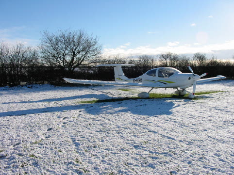 Plane unprotected in the snow - needs a hanger