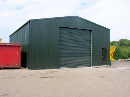 Simple steel shed used as agricultural machine workshop