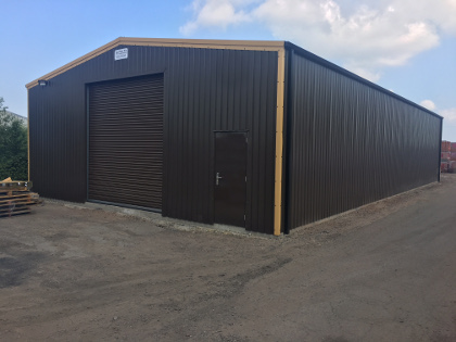 Hercocks simple steel barn in dark chocolate cladding